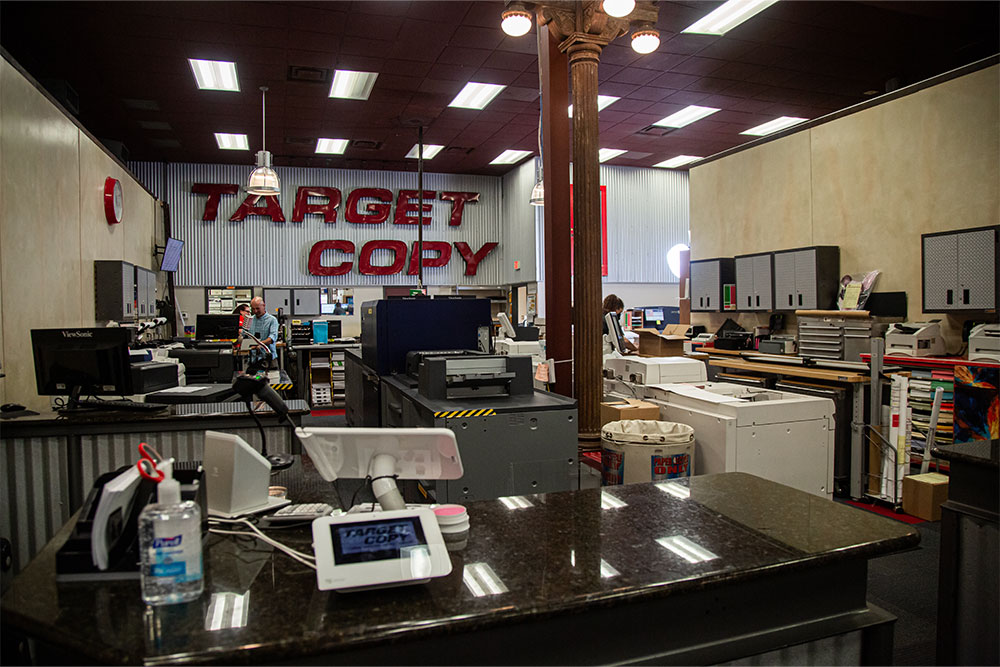 Interior of Target Copy Office showing front desk, copiers, and printers in the background